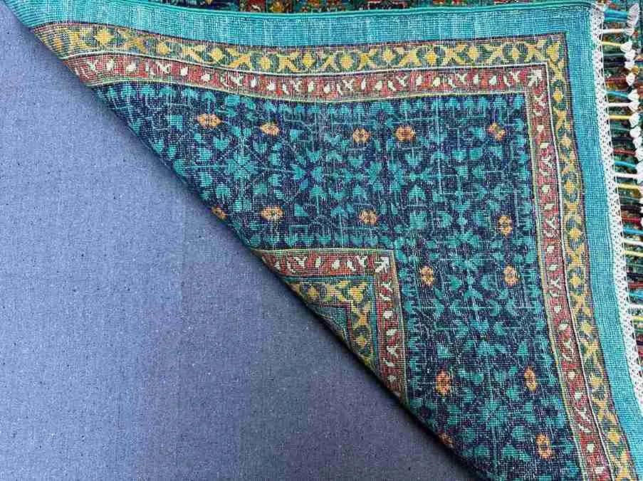 Side view of folded vintage Mamluk rug – knotted wool and silk texture