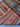 Folded multicolor Oriental rug showing wool texture and density