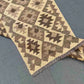 Layered folded display showing Kilim texture and pattern