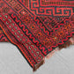 Folded view of vintage Turkish Kilim rug – red and black wool flatweave in 8x13 size.