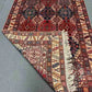 Folded view of handmade 5x7 Waziri rug showcasing quality wool
