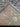 Folded 5x9 blue and beige Persian-style rug showing backside knotting