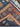Persian-style hallway rug partially folded showing weave and thickness.