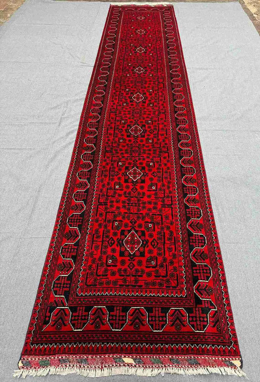Top-down full view of 3x13 handmade Turkish-Afghan red runner rug in Oriental style