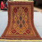 Full top-down view of handmade red and gold Afghan kilim rug