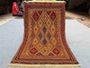 Full top-down view of handmade red and gold Afghan kilim rug
