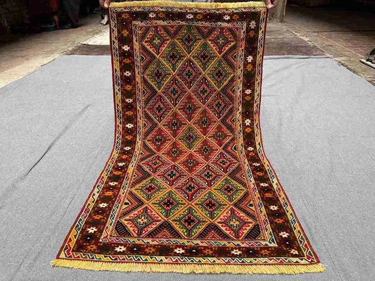 Full top view of handwoven 2.5x4.3 Turkish Afghan runner rug with red, green, and gold tribal geometric design