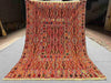 Full top-down view of 4.9x6.6 Turkish Afghan kilim rug with geometric tribal design in red and orange