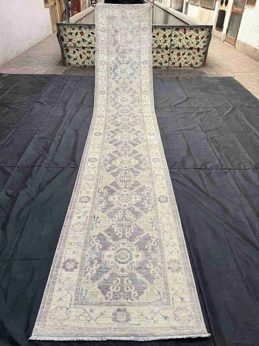 Full view of extra-long 14ft Oushak runner rug in soft pastel tones