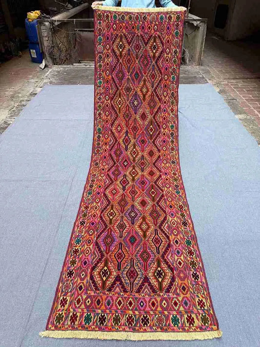 Complete view of 2.9x9.3 antique Turkish kilim runner with tribal design