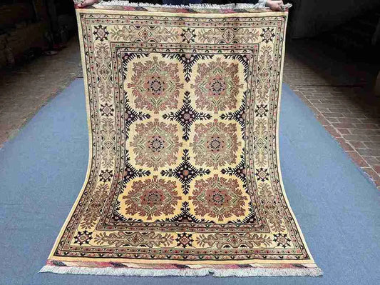Full view of handmade 5x7 Afghan Oriental rug in red and beige