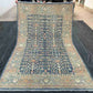 Full overhead view of handmade 5x9 blue and beige wool Tree of Life rug
