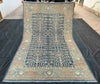 Full overhead view of handmade 5x9 blue and beige wool Tree of Life rug