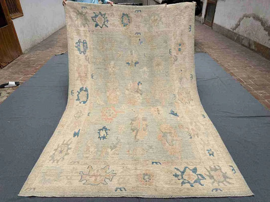 Full overhead view of 6x9 handmade Turkish Oushak rug with floral pastel design