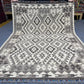 Full top-down view of 5x7 black and white tribal Turkish Kilim rug.