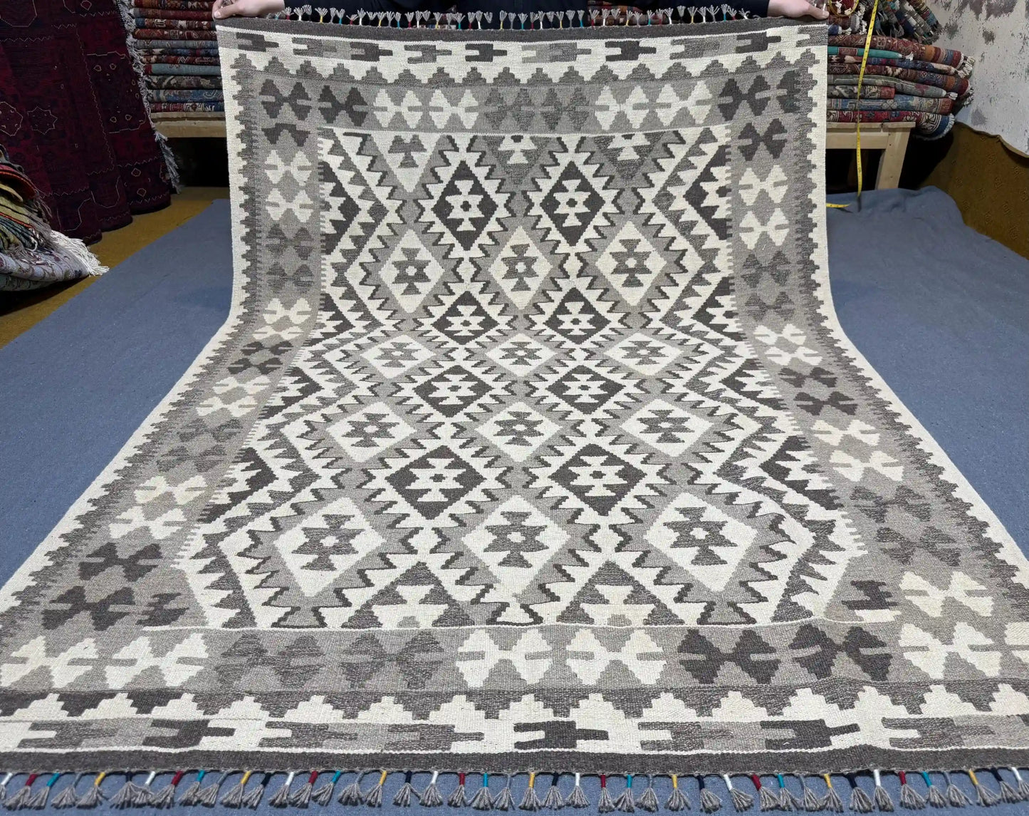 Full top-down view of 5x7 black and white tribal Turkish Kilim rug.