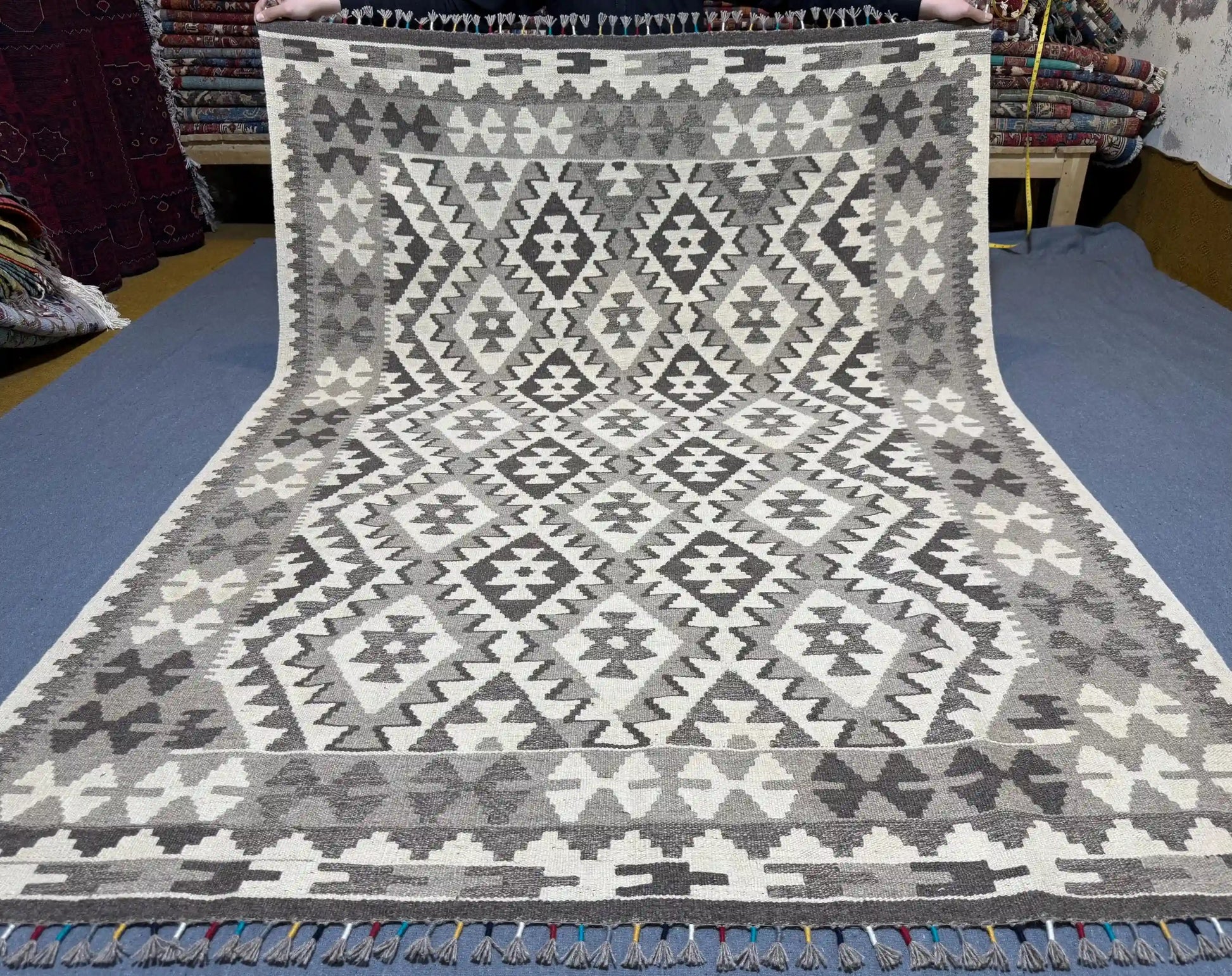 Full top-down view of 5x7 black and white tribal Turkish Kilim rug.