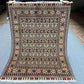 Full top-down view of handmade 5x7 Oriental rug with floral and geometric patterns