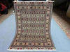 Full top-down view of handmade 5x7 Oriental rug with floral and geometric patterns