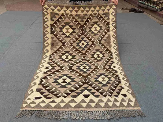 Full view of small handmade Turkish Kilim rug – traditional flatweave with tribal motifs.