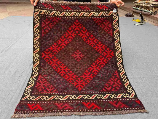 Full view of handwoven small red Afghan Kilim rug – geometric wool flatweave accent carpet.