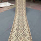 Full view of handmade beige and brown kilim runner rug