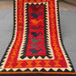 Full view of handmade vintage Turkish Kilim rug – red and orange tribal wool flatweave in boho style.