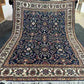 Full top-down view of navy and cream floral Chobi wool rug
