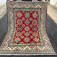Full top-down view of authentic 5x7 red & beige Turkish Kazakh wool rug