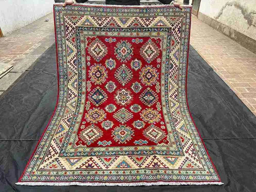 Full top-down view of authentic 5x7 red & beige Turkish Kazakh wool rug