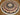 Full top-down image of round Persian-style handmade silk carpet