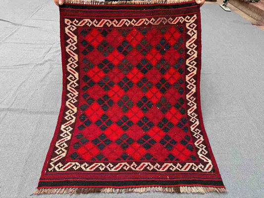 Full view of handmade vintage red Afghan Kilim rug – small wool flatweave with geometric tribal design.