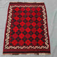 Floor setup with geometric Afghan Kilim rug – small red wool carpet perfect for boho spaces.