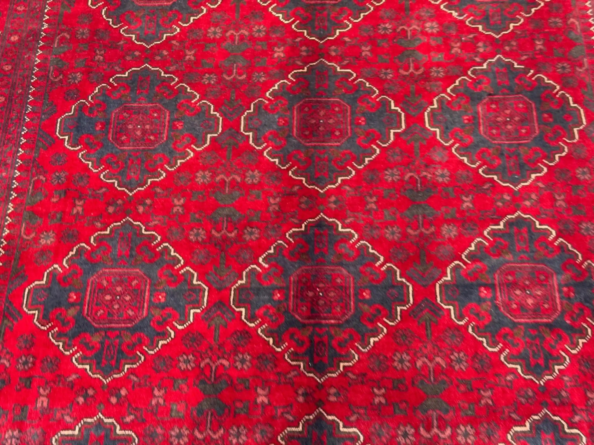 Close-up of geometric tribal design on Afghan vintage wool rug
