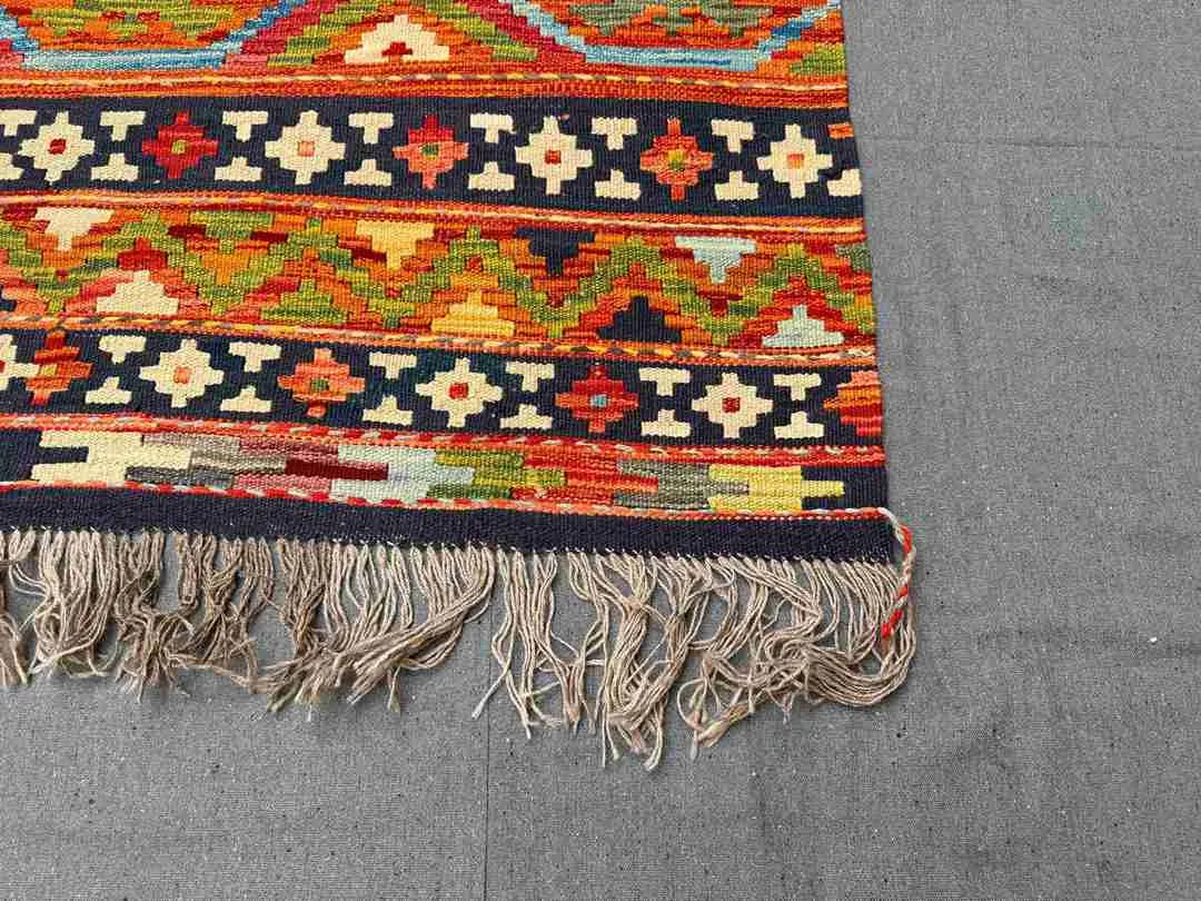 Corner detail of multicolor Khorjin Kilim rug – large handwoven geometric wool flatweave.