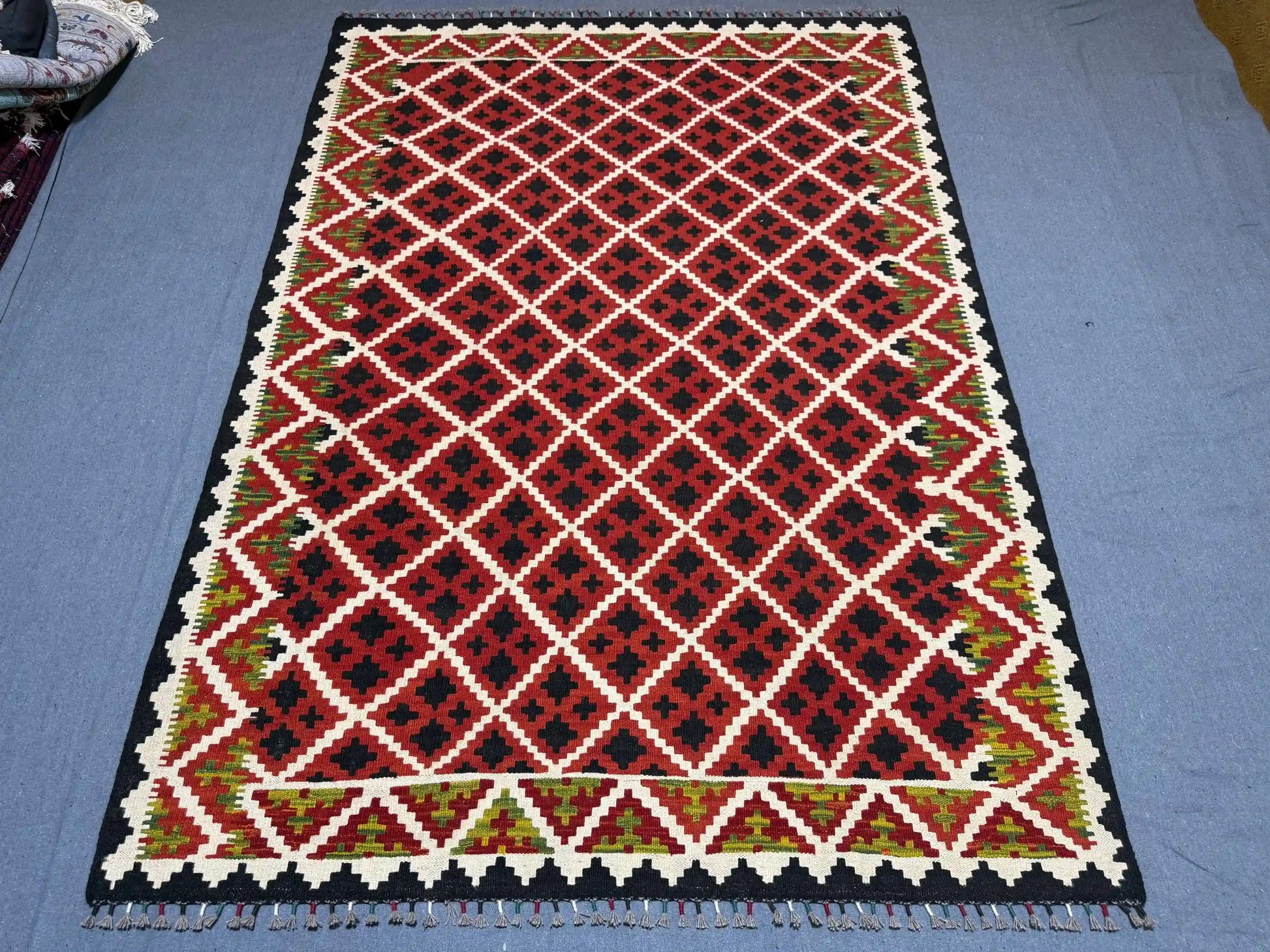  Floor view of red tribal kilim rug – geometric flatweave wool carpet