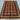 Handwoven red and yellow wool rug styled on hardwood floor