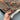 Handmade 4.11x6.10 gray Sultani rug held in hands showing floral pattern