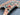 Handmade green and red Ziegler rug held in hands, showing quality craftsmanship