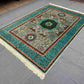 Green and turquoise artisan rug decorating contemporary floor space