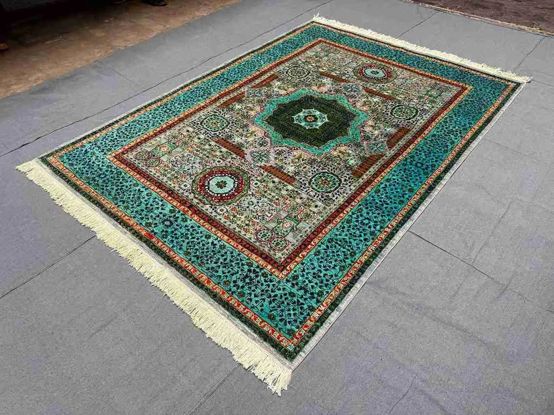 Green and turquoise artisan rug decorating contemporary floor space