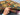 Knotted 4x7 Oriental patchwork rug in hand with colorful wool details