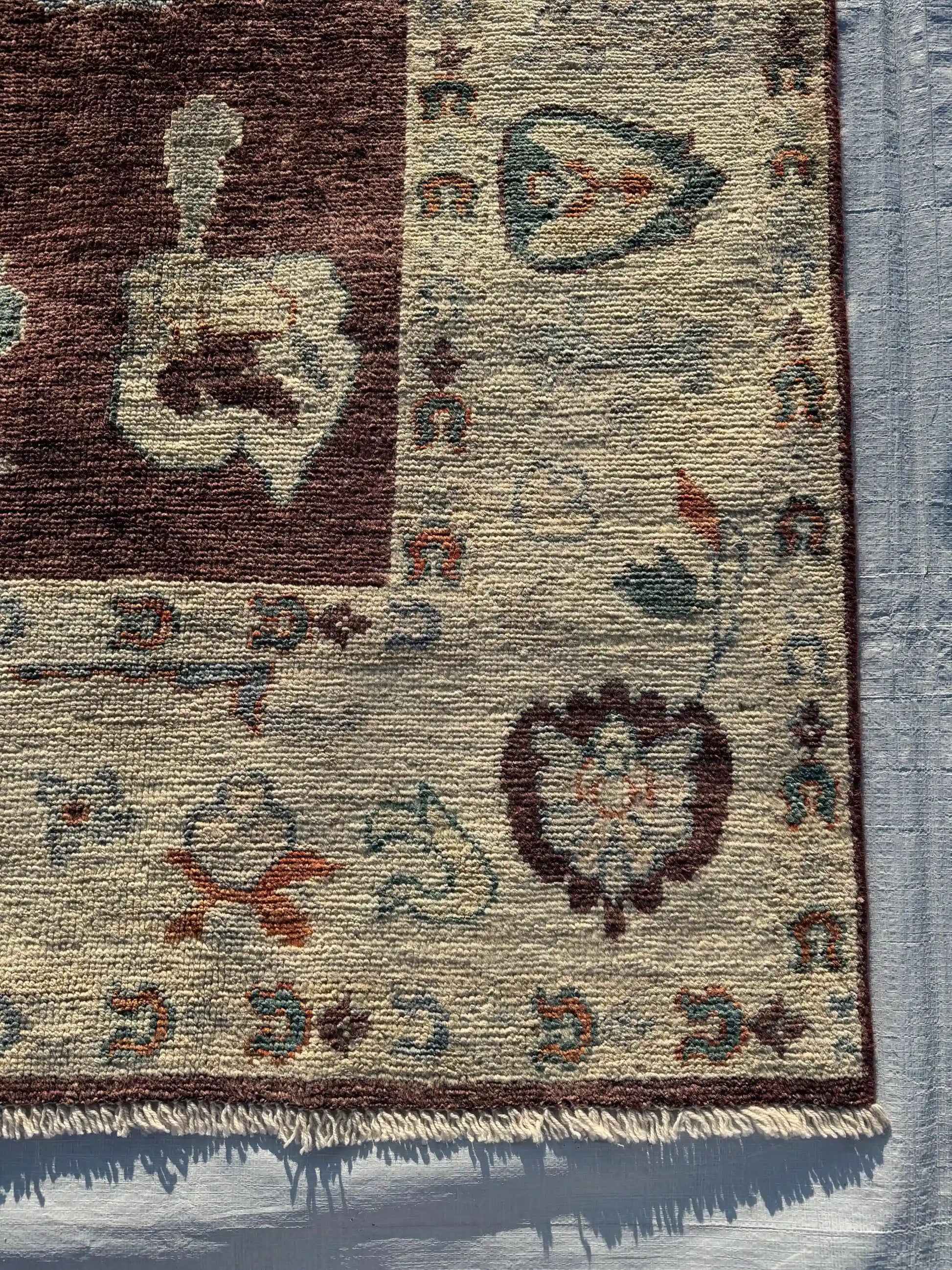 Corner close-up of hand-knotted Turkish Oushak wool rug with intricate patterns