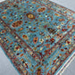 Handmade floral wool rug on hardwood floor – area decor