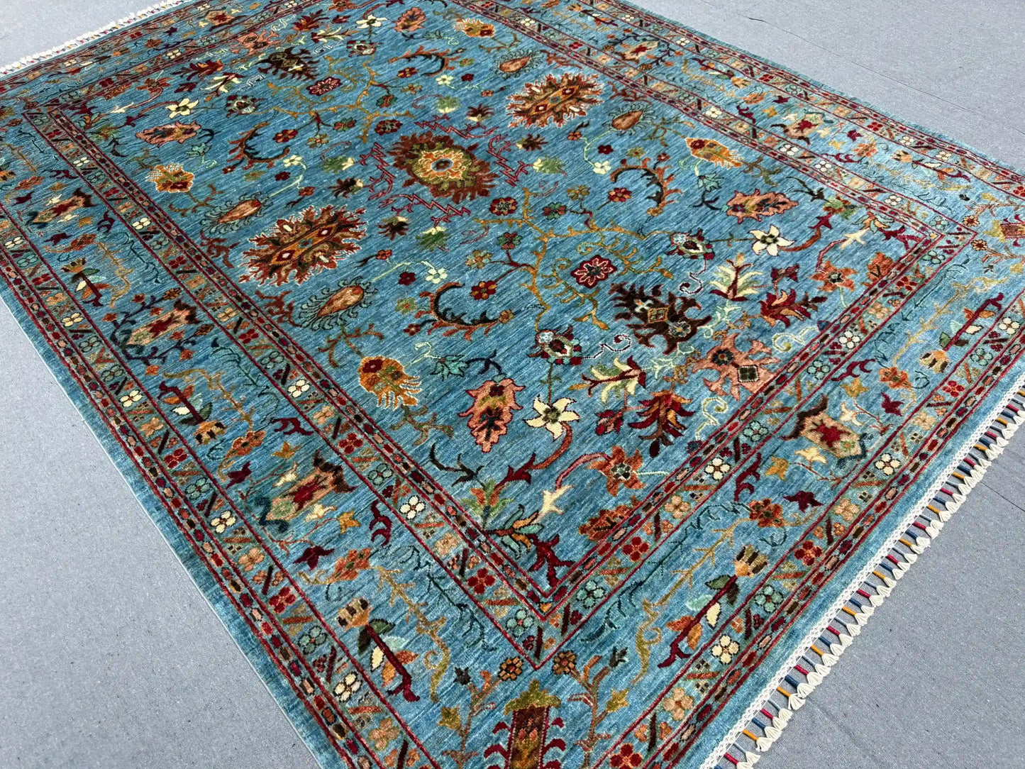 Handmade floral wool rug on hardwood floor – area decor