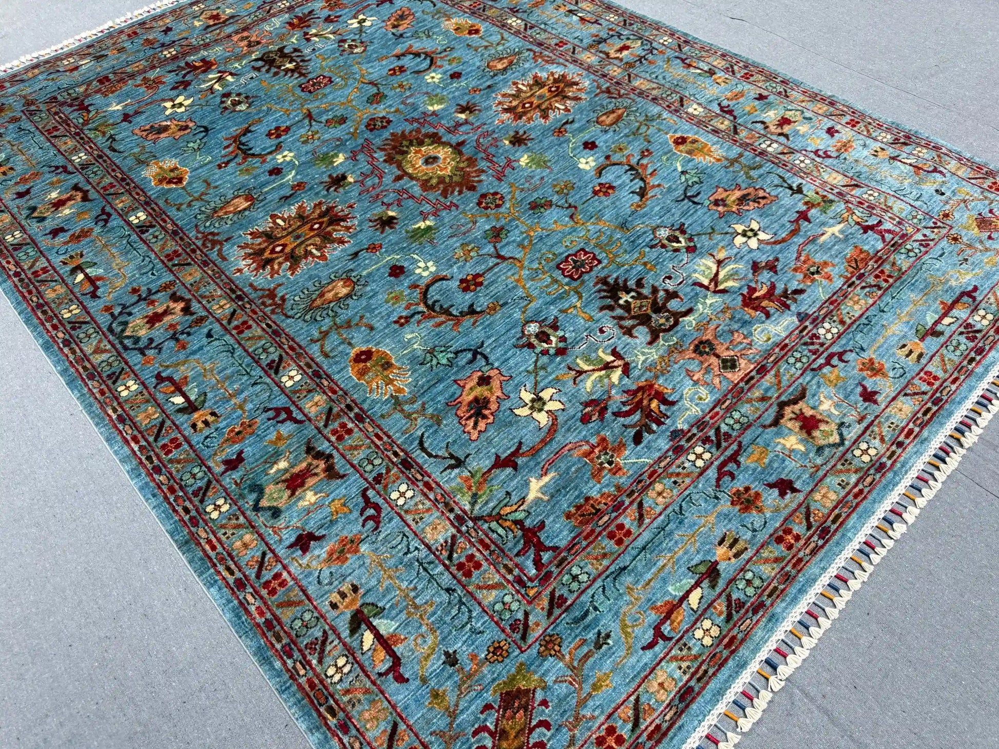 Handmade floral wool rug on hardwood floor – area decor