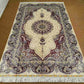 5x8 handmade silk rug displayed on hardwood living room floor