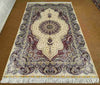 5x8 handmade silk rug displayed on hardwood living room floor