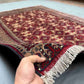 Handmade 5x7 Afghan rug in hands – red and beige wool silk Turkish carpet