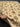 Authentic handmade cream floral wool carpet held in hands – traditional beige knotted carpet
